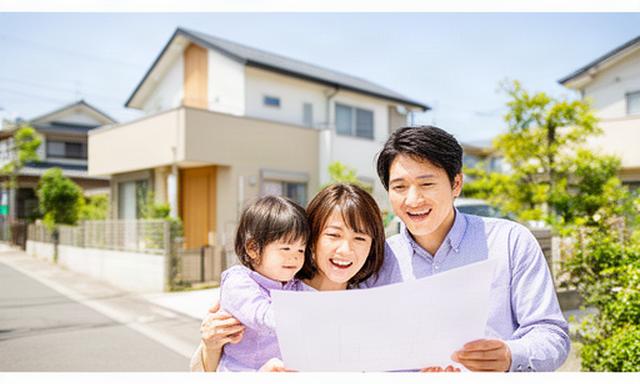 佐賀の明るい住宅街で新居の図面を囲む30代夫婦と子ども